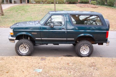 1994 Ford Bronco - This 1994 Ford Bronco is shown in a side profile, a dark green exterior and lifted suspension.