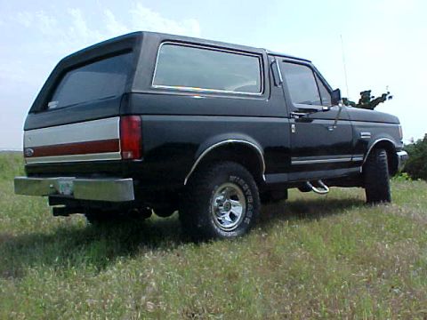 1989 Ford Bronco - This 1987 Ford Bronco is viewed from the rear three-quarter angle, its distinctive body style and chrome accents.