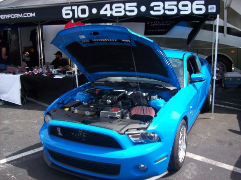 2007 Ford Mustang - Blue 2007 Ford Mustang on display with hood open, revealing the engine compartment.