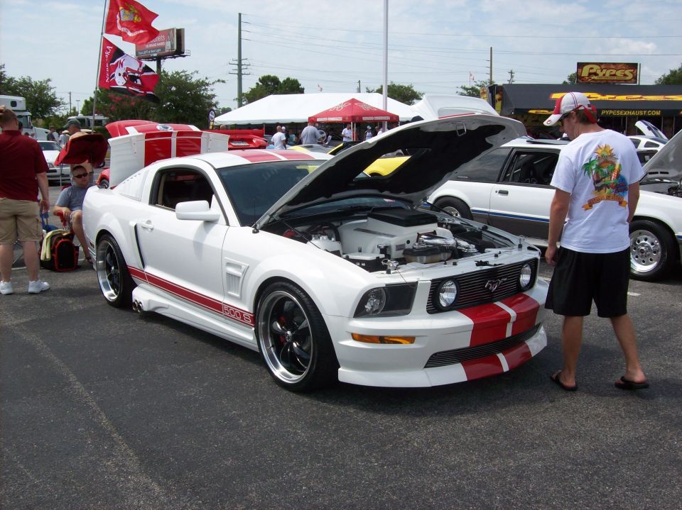 White 2007 Ford Mustang with red stripes, hood open, 3q-front view