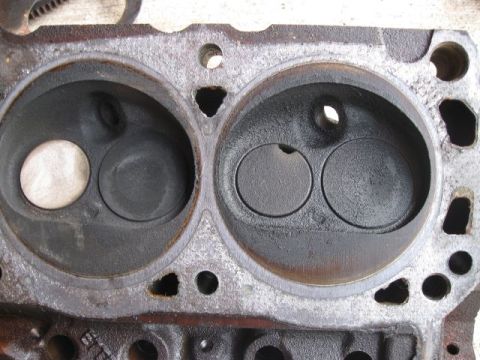 1992 Ford Bronco - Close-up of an engine cylinder head, showing two combustion chambers with valves visible.