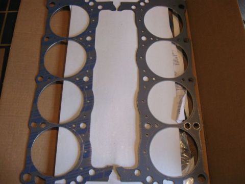 1992 Ford Bronco - A head gasket, likely for an engine, is shown laid out on a cardboard surface.