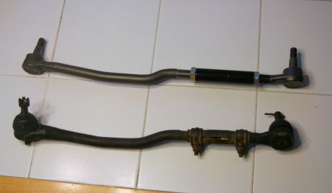 1976 Ford Ranchero - Comparison of a new tie rod assembly with an older, rusted unit, likely for a vehicle's suspension system.