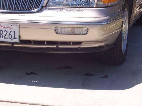 1997 Mercury Grand Marquis - Close-up of the front bumper and grille area of a 1997 Mercury Grand Marquis.