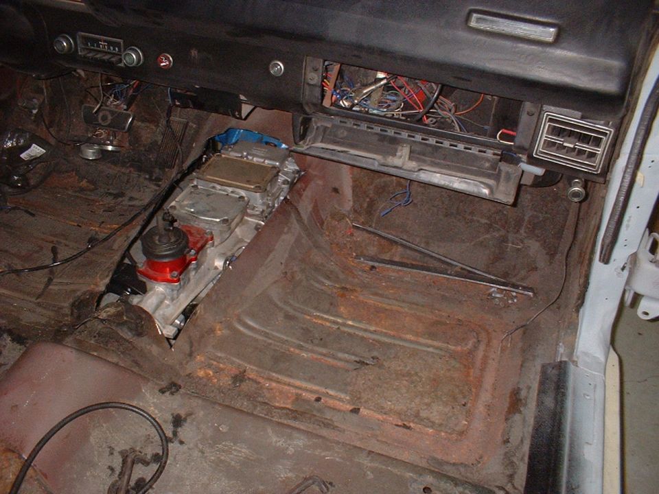 Interior view of car with transmission and exposed wiring