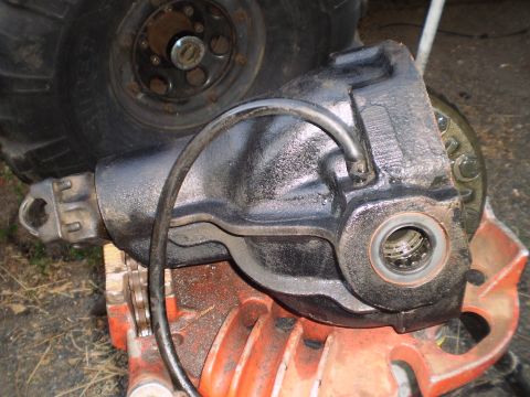 1978 Ford Bronco - Close-up of a vehicle differential housing with a tire visible behind it.