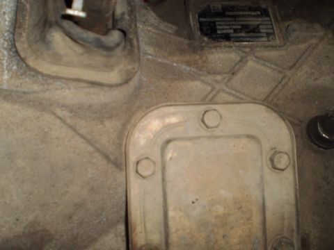 1978 Ford Bronco - Transmission housing detail with a data plate and bolted cover. No vehicle is visible.