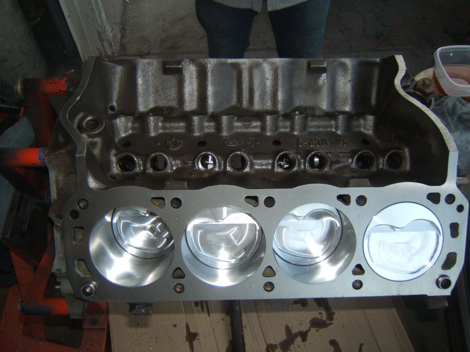 Ford V8 engine block with four pistons installed in cylinders