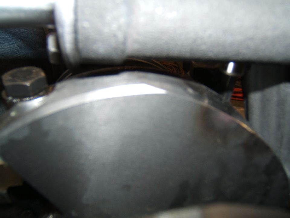 Close-up of a metal engine component with a hex bolt visible