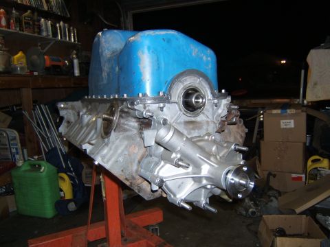 1988 Ford Bronco - A Ford V8 engine block, likely undergoing rebuild or modification, is mounted on an engine stand in a cluttered garage.