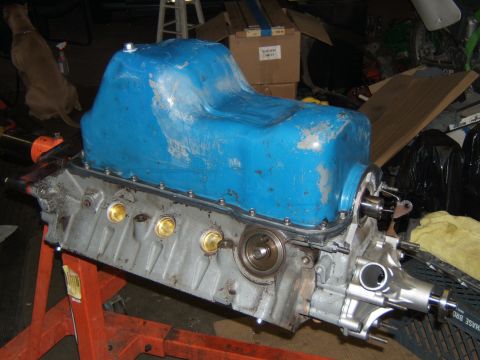 1988 Ford Bronco - Engine block with blue oil pan on an orange stand, with a dog in the background.