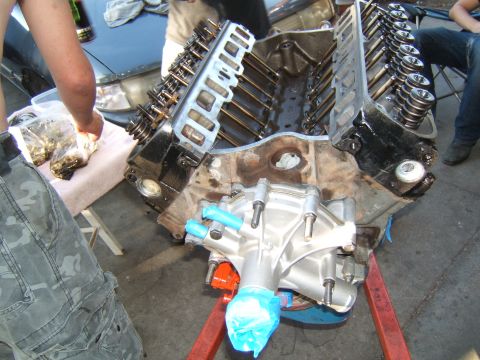 1988 Ford Bronco - Engine block assembly on a stand, with parts laid out for work.