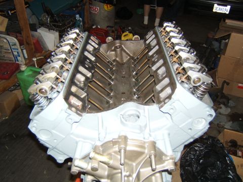 1988 Ford Bronco - A V8 engine block is shown, partially assembled with rocker arms and valve springs installed.