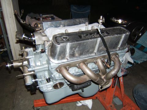 1988 Ford Bronco - A Ford V8 engine, likely a Windsor small block, is mounted on an engine stand, ready for installation or undergoing assembly.