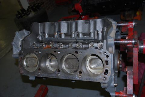 1996 Ford Bronco - Close-up of an engine block, showing the cylinders and pistons, mounted on a stand.