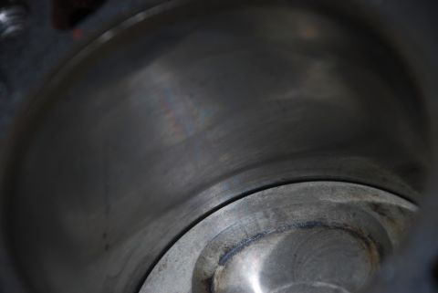 1996 Ford Bronco - A close-up view of the interior of an engine cylinder, showing wear marks on the metal surface.