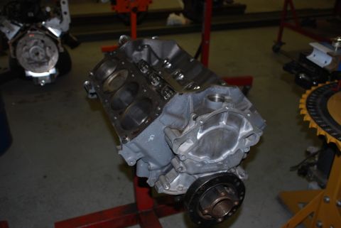 1996 Ford Bronco - Engine block on a stand in a workshop, with another engine visible in the background.