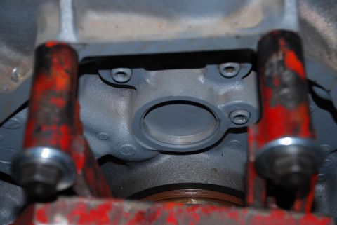 1996 Ford Bronco - Close-up view of an engine block, red metal supports and a central circular opening.