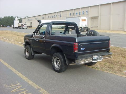 1993 Ford Bronco - Rear view of a Ford Bronco with a snorkel and spare tire visible.