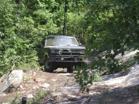 1990 Ford Bronco - This Ford Bronco is parked on a rocky, wooded trail.