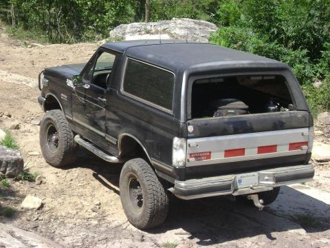 1990 Ford Bronco - This 1990 Ford Bronco is seen off-road, showing its lifted suspension and aftermarket wheels.