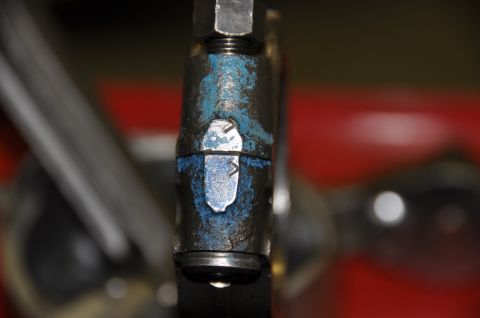 1996 Ford Bronco - A close-up view of a metal component with blue paint markings and a visible nut.