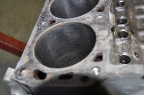 1996 Ford Bronco - Close-up view of the cylinders within an engine block, revealing internal wear patterns.