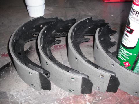 1991 Ford Bronco - Close-up of four drum brake shoes, a component of a vehicle's braking system.
