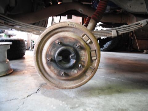1991 Ford Bronco - Close-up view of a drum brake assembly, showing the brake shoes and hub. Text 'FIKO A' is visible on the drum.