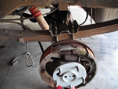 1991 Ford Bronco - Close-up of a vehicle's rear drum brake assembly, showing suspension components.