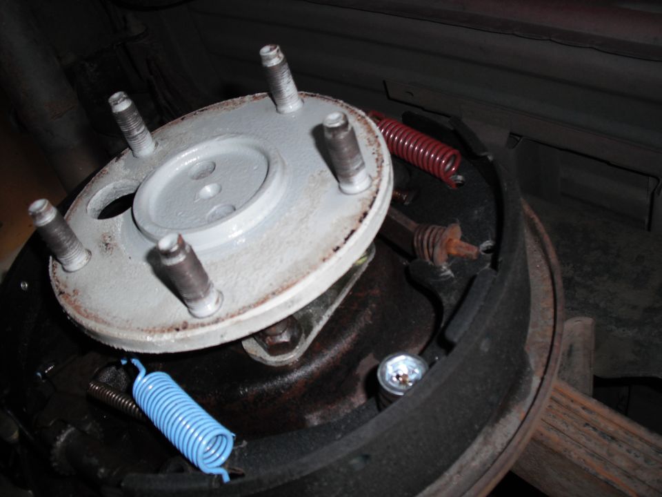 Close-up of a vehicle's drum brake assembly with new springs installed