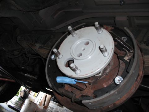 1991 Ford Bronco - Close-up of a vehicle's drum brake assembly, showing components like brake shoes and springs.