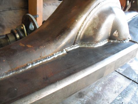 1991 Ford Bronco - This photo shows a close-up view of a metal axle housing with fresh welds along its seams.