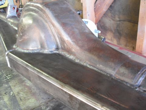 1991 Ford Bronco - Close-up view of a metal axle housing, showing welded seams and structural details.