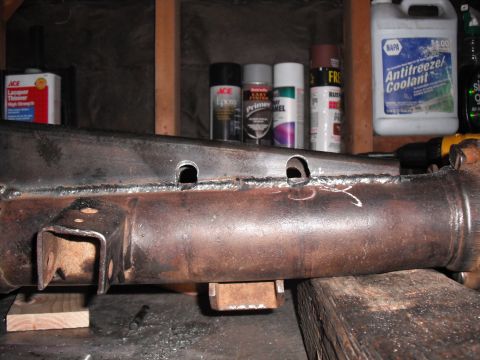 1991 Ford Bronco - Axle housing with fresh welds and drilled holes, likely undergoing modification or repair.