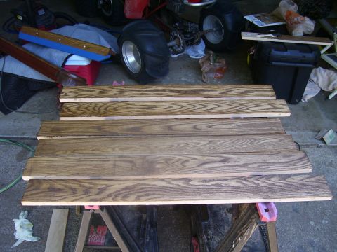 1991 Ford Bronco - Wooden planks are laid out on sawhorses in a garage setting.