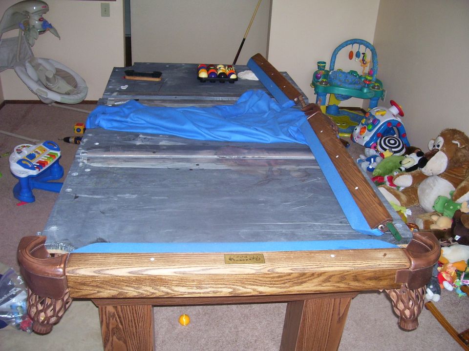 Pool table with blue felt and billiard balls