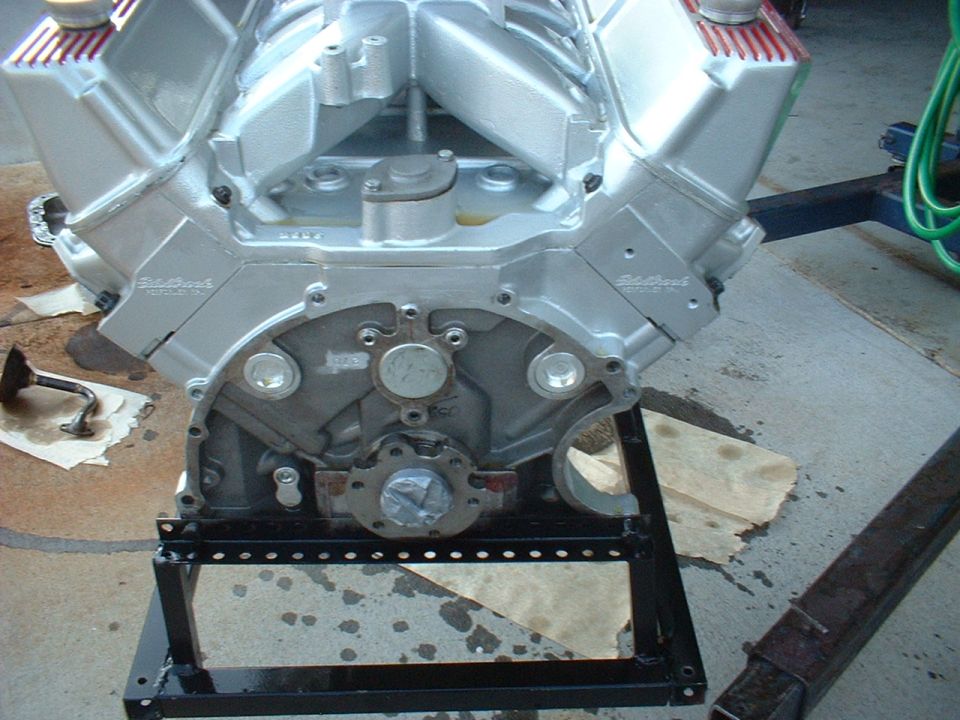 Silver V8 engine on stand, showing Edelbrock branding