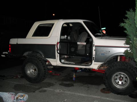 1991 Ford Bronco - This lifted 1991 Ford Bronco features off-road tires and custom tube doors, suggesting modifications for off-road use.