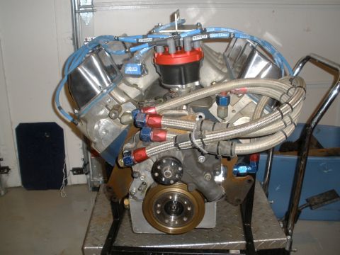 1995 Ford Bronco - A V8 engine with custom fuel lines and ignition system is displayed on a stand.
