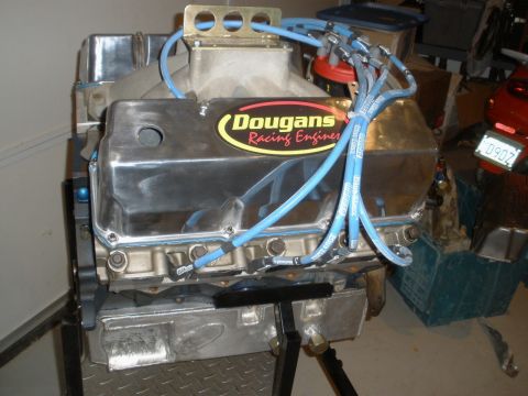 1995 Ford Bronco - A close-up view of a chrome engine assembly, blue spark plug wires and a prominent racing engine sticker.