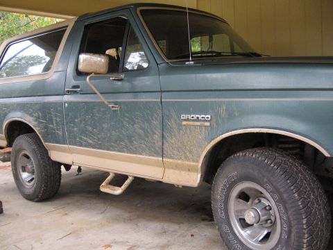 1989 Ford Bronco - This 1989 Ford Bronco is seen from a 3/4 front angle, highlighting its green paint and tan lower trim.
