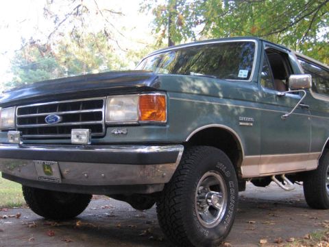 1989 Ford Bronco - This 1989 Ford Bronco features a prominent chrome bumper and "4x4" badging on the front fender.