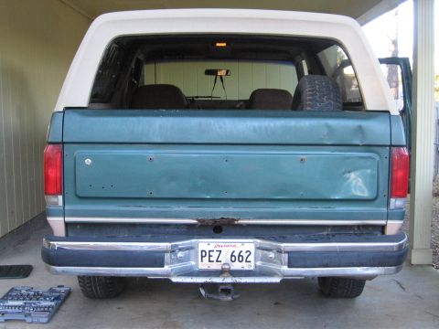1989 Ford Bronco - 1989 Ford Bronco rear view, showing the teal body and white hardtop. License plate PEZ 662 is visible.