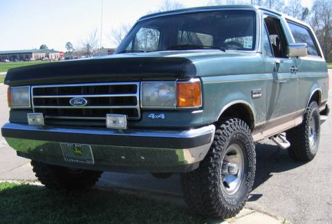 1989 Ford Bronco - This 1989 Ford Bronco features a two-tone paint scheme and prominent 4x4 badging.