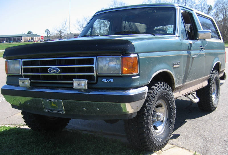Green 1989 Ford Bronco 4x4 with aftermarket wheels and tires