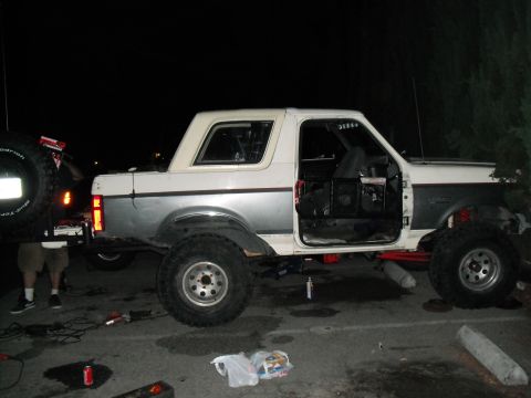1991 Ford Bronco - A modified Ford Bronco sits with its doors off, elevated on off-road tires.