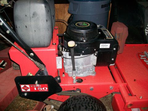 1983 Ford F-250 - Close-up of a lawnmower engine and deck, showing the "PRO 150 12.5 HP" label.