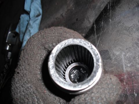1991 Ford Bronco - Close-up of a splined shaft within a metal housing, likely a vehicle part.