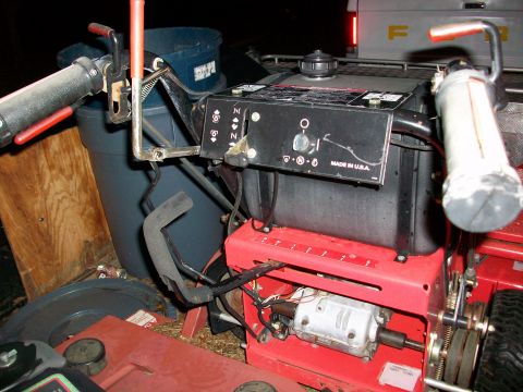 1983 Ford F-250 - Close-up view of a lawnmower's engine and control panel, with a truck visible in the background.